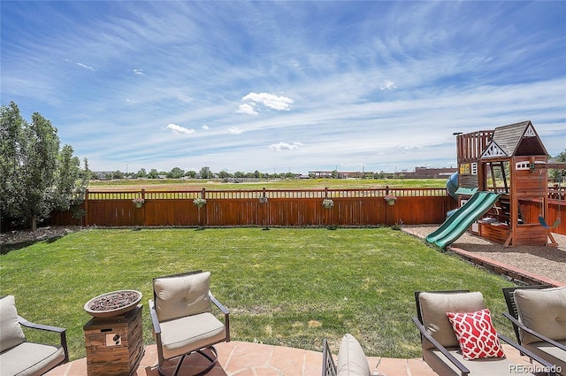 view of yard featuring a playground and fence