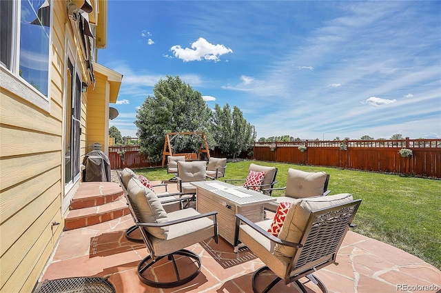 view of patio featuring an outdoor living space with a fire pit and a fenced backyard