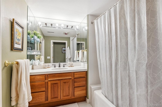 full bathroom with visible vents, vanity, and shower / bath combo with shower curtain