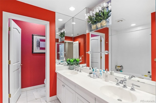 full bath featuring double vanity, recessed lighting, toilet, and a sink