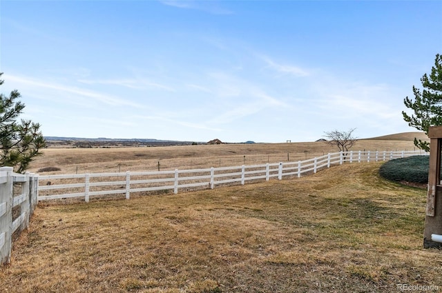 view of yard with a rural view and fence