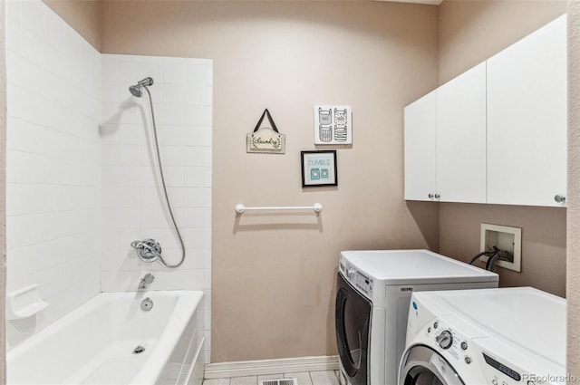 washroom featuring baseboards, cabinet space, independent washer and dryer, and visible vents