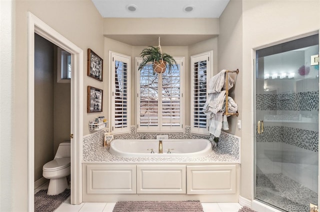 full bath with tile patterned floors, toilet, a stall shower, and a bath