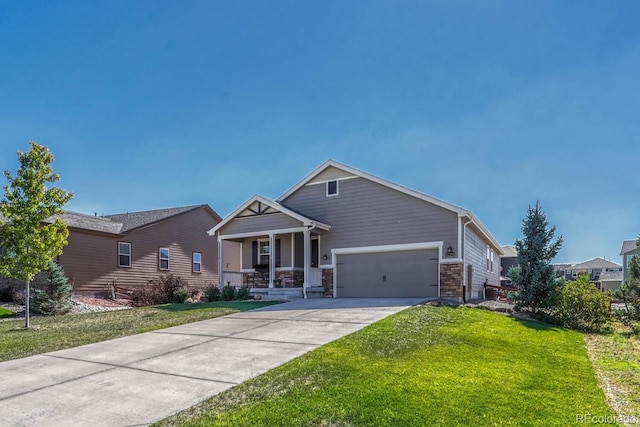 craftsman-style house with concrete driveway, stone siding, an attached garage, a porch, and a front yard