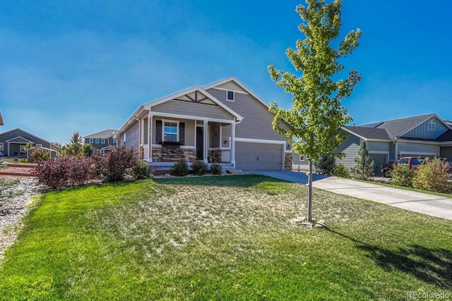 craftsman house with a garage, covered porch, driveway, and a front lawn