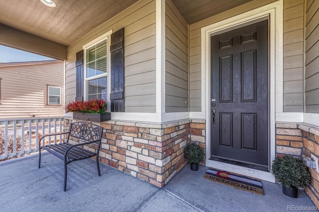 view of exterior entry featuring a porch