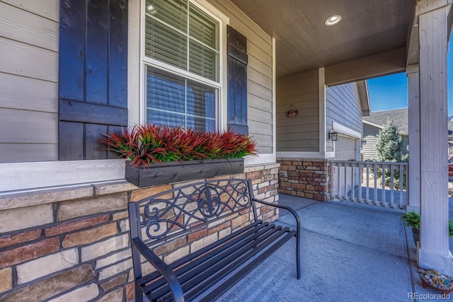 doorway to property with covered porch and stone siding