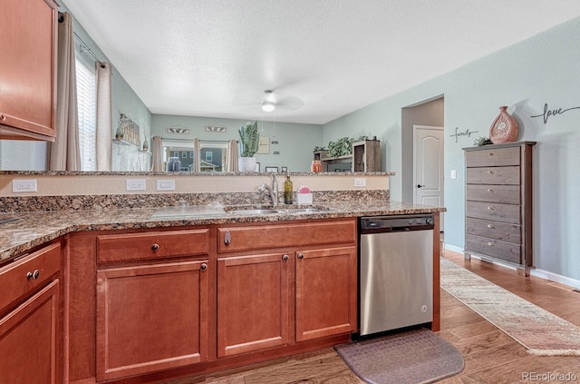 kitchen with a textured ceiling, dishwasher, ceiling fan, and sink