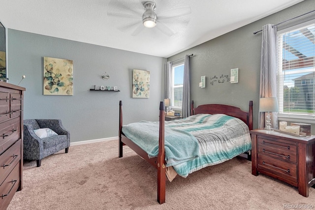 carpeted bedroom featuring ceiling fan and multiple windows