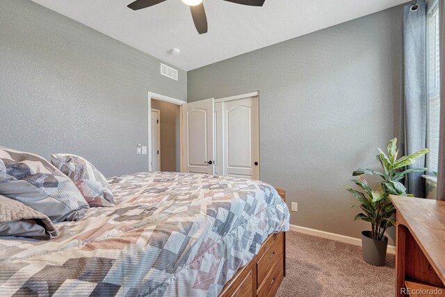 bedroom with a closet, light colored carpet, and ceiling fan