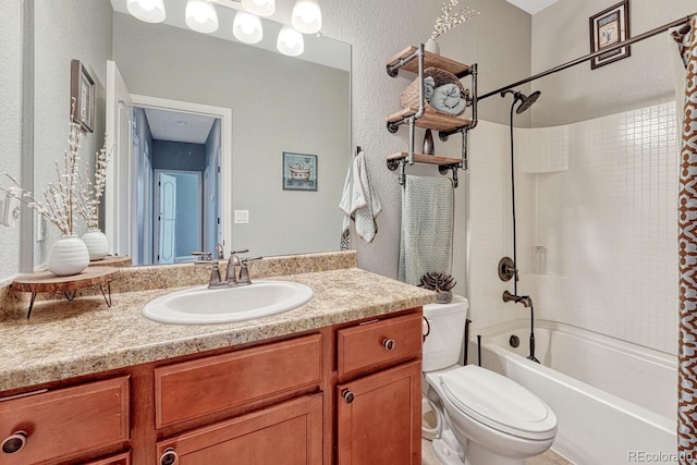 bathroom featuring shower / bath combo, a textured wall, vanity, and toilet