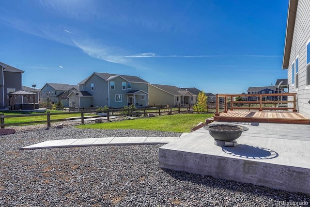 view of yard with an outdoor fire pit and a wooden deck