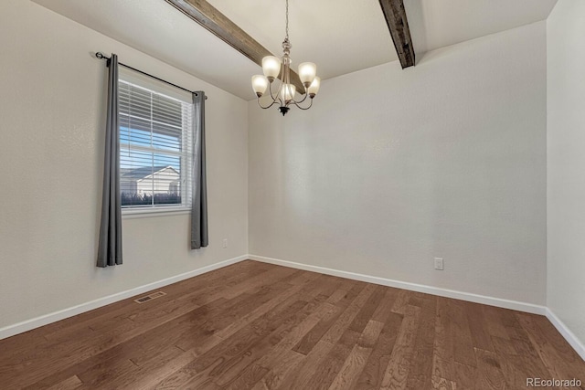 empty room featuring baseboards, visible vents, dark wood finished floors, beamed ceiling, and a chandelier