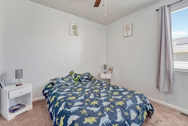 carpeted bedroom featuring ceiling fan, visible vents, and baseboards