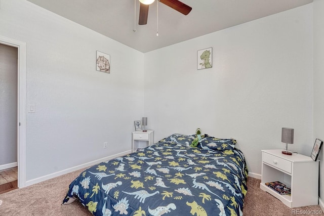 carpeted bedroom featuring a ceiling fan and baseboards