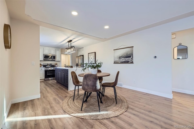 dining room with light hardwood / wood-style floors