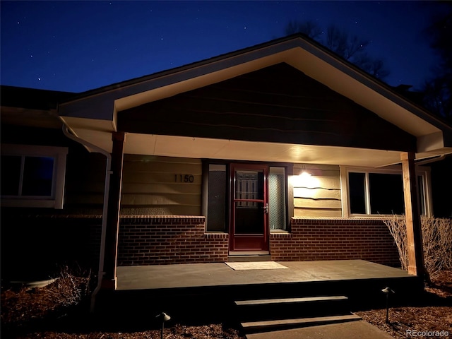 view of exterior entry at night