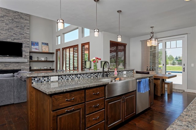 1315 W 141st Cir, Westminster, CO 80023 - kitchen featuring stainless steel dishwasher, plenty of natural light, dark wood finished floors, and open floor plan