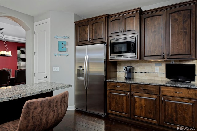 1315 W 141st Cir, Westminster, CO 80023 - kitchen featuring stainless steel appliances, light stone counters, tasteful backsplash, dark wood-type flooring, and dark brown cabinetry