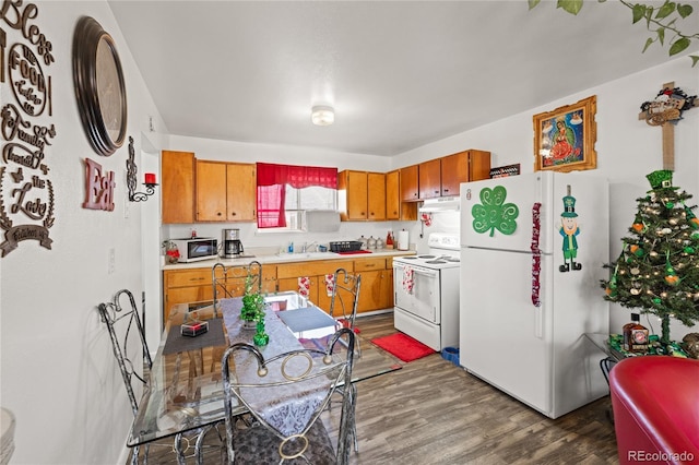1112 W Mesa Ave Unit 1114, Pueblo, CO 81004 - kitchen featuring white appliances, a sink, wood finished floors, light countertops, and brown cabinetry