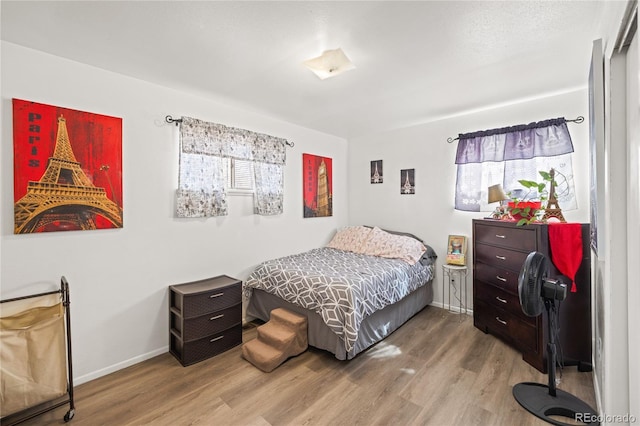 1112 W Mesa Ave Unit 1114, Pueblo, CO 81004 - bedroom featuring multiple windows, wood finished floors, and baseboards