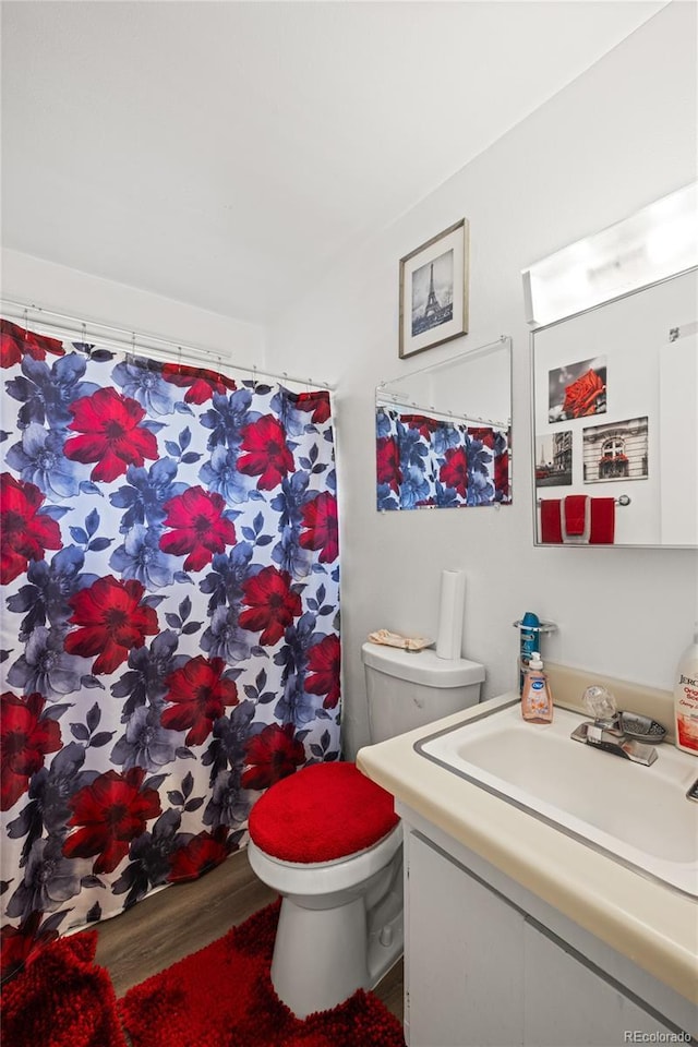 1112 W Mesa Ave Unit 1114, Pueblo, CO 81004 - bathroom with toilet, vanity, wood finished floors, and curtained shower