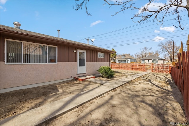 1112 W Mesa Ave Unit 1114, Pueblo, CO 81004 - rear view of house featuring board and batten siding, a fenced backyard, and a patio area
