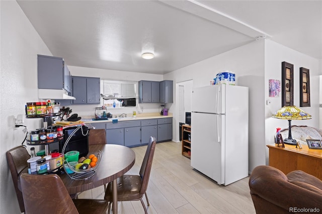 1112 W Mesa Ave Unit 1114, Pueblo, CO 81004 - kitchen with freestanding refrigerator, a sink, light countertops, light wood-style floors, and gray cabinetry