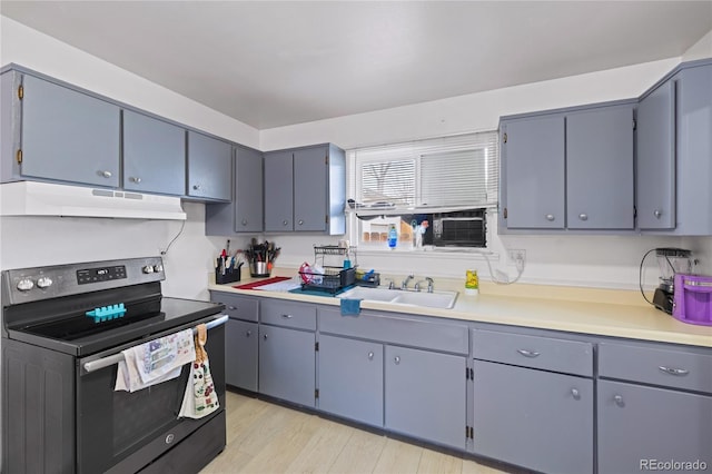1112 W Mesa Ave Unit 1114, Pueblo, CO 81004 - kitchen with electric range oven, a sink, under cabinet range hood, light countertops, and gray cabinets