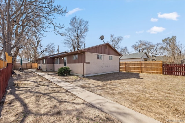 1112 W Mesa Ave Unit 1114, Pueblo, CO 81004 - view of side of home featuring a fenced backyard and board and batten siding