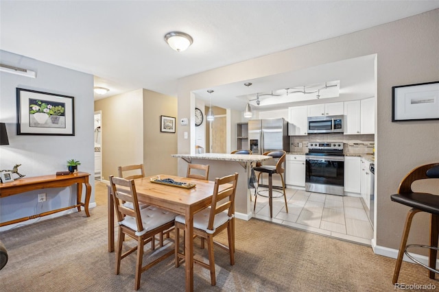 dining area with light tile patterned floors