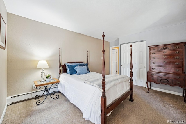 bedroom with baseboard heating, carpet flooring, and a closet