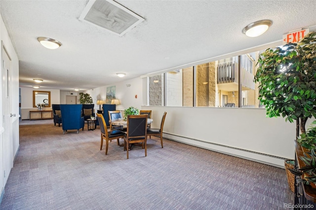 dining space with carpet floors, a textured ceiling, and a baseboard radiator