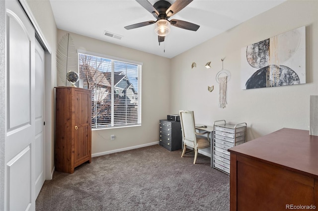 carpeted home office featuring ceiling fan, visible vents, and baseboards