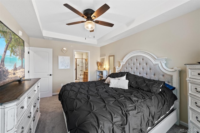 bedroom with baseboards, a raised ceiling, connected bathroom, ceiling fan, and carpet floors