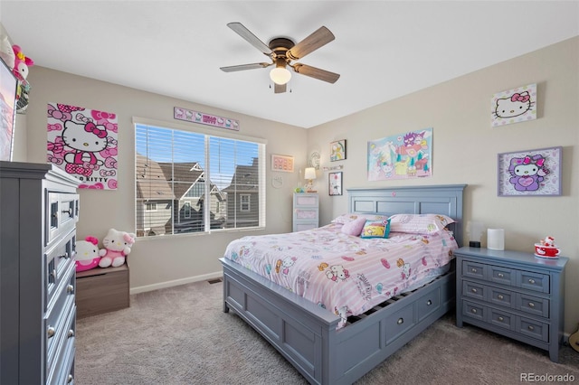 bedroom with ceiling fan, baseboards, and carpet flooring