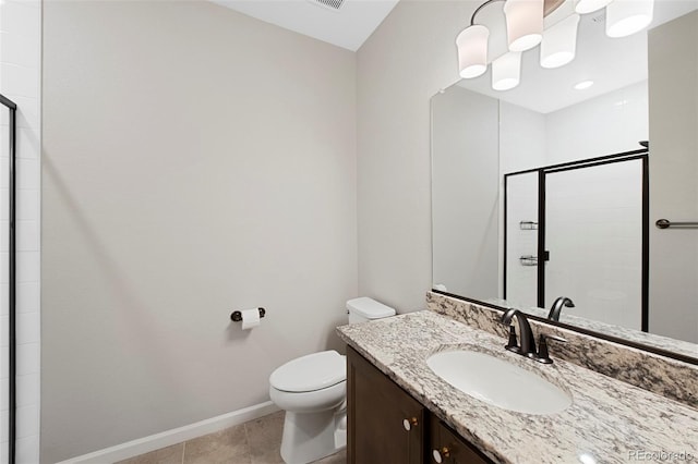 bathroom with vanity, baseboards, a stall shower, and toilet