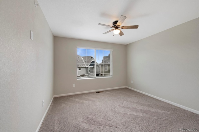 empty room with baseboards, carpet, and a ceiling fan
