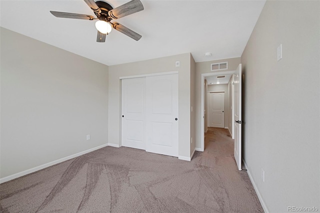 unfurnished bedroom with carpet flooring, baseboards, visible vents, and a closet