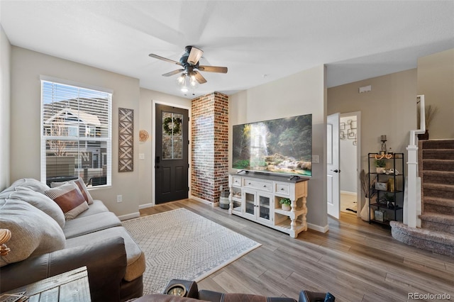 living room with baseboards, stairs, and wood finished floors
