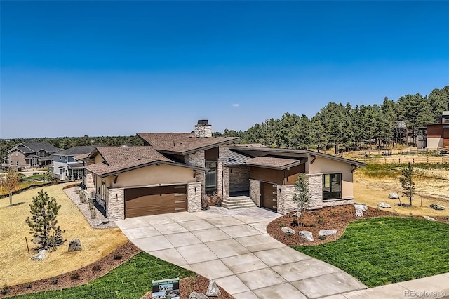 view of front of home featuring a garage and a front lawn