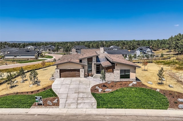 view of front of house featuring a garage and a front yard