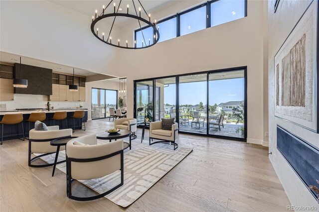 living room featuring a chandelier and light wood-type flooring