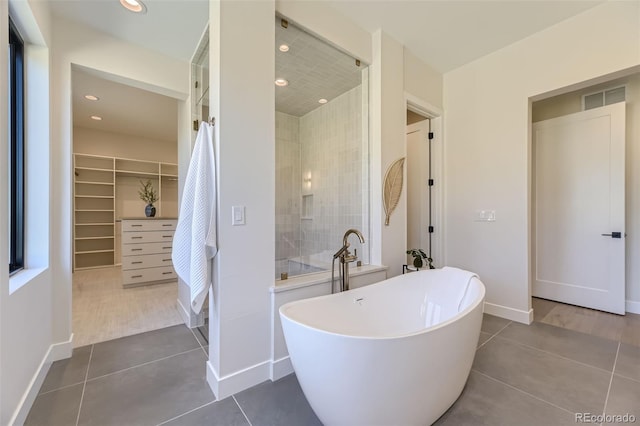 bathroom featuring tile patterned floors and separate shower and tub