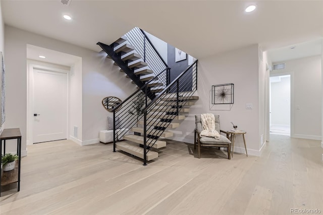 stairway featuring hardwood / wood-style flooring