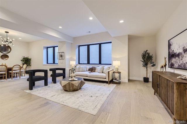 living room featuring a notable chandelier and light hardwood / wood-style floors