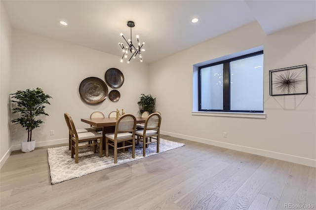 dining space with an inviting chandelier and light wood-type flooring