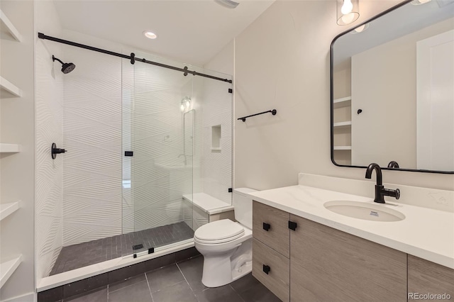 bathroom with tile patterned flooring, vanity, toilet, and an enclosed shower