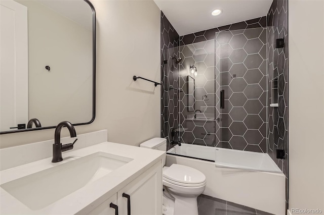 full bathroom with tiled shower / bath, vanity, and toilet