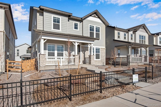 view of front of property featuring a porch and a fenced front yard